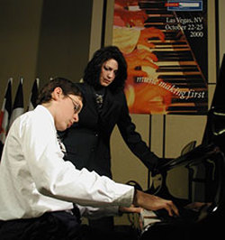 Deborah Aitken demonstrating teaching techniques with student Thomas Coffee as Guest Clinician -- World Piano Pedagogy Conference, Las Vegas